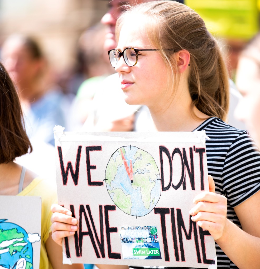 The figure shows a girl holding a poster that highlights the importance of water conservation